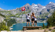 © M.studio - happy family travaling in Switzerland,  Oeschinensee lake and alps mountain