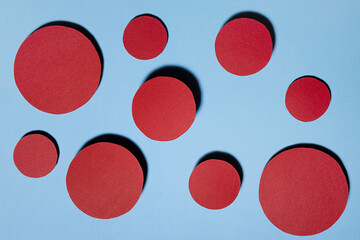 Poster - Colorful abstract dotted background with red textured circles fly on blue color with shadow in funny playful minimalist style.