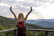 © Angelov - stylish traveler woman relaxing in mountains. hipster on top of mountain, resting. space for text. atmospheric moment. wanderlust and travel concept.