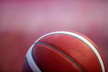 Wall Mural - Professional basketball ball on the parquet with black background. Horizontal sport theme poster, greeting cards, headers, website and app.