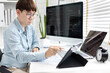 © Puwasit Inyavileart - Professional development programmers are using tablet to test the functionality of their applications after programming, Write data or code for websites and applications,  HTML, javascript, Software.