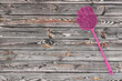 Pink Flyswatter in Shape of Hand on a wooden table. 3d Rendering