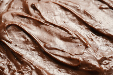 Wall Mural - a close-up on chocolate ganache or pudding with swirls and spreads filling the frame, selective focus