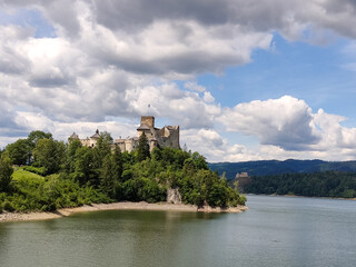 Wall Mural - Niedzica Castle Also Known as Dunajec Castle by Lake Czorsztynin the Pieniny Mountains, Poland. And Tourist Ferrys in the Lake. Summer Day With Fast Moving Clouds.  Czorsztyn Castle at the Background