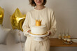 © ADDICTIVE STOCK - Unrecognizable woman holding a cupcake
