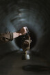 © ADDICTIVE STOCK - Anonymous man exploring underground tunnel