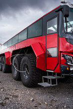 Contemporary Glacial Expedition Bus Parked Under Overcast Sky