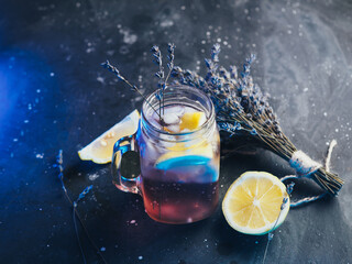 Wall Mural - glass mug with craft lavender lemonade. refreshing summer cold drink with lavender syrup and lemon j