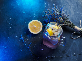 Wall Mural - glass mug with craft lavender lemonade. refreshing summer cold drink with lavender syrup and lemon j