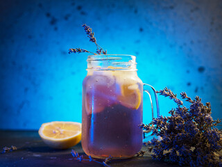 Wall Mural - glass mug with craft lavender lemonade. refreshing summer cold drink with lavender syrup and lemon j