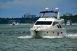 White motor yacht cruising on the Florida `intra-Coastal Waterway off of `Miami Beach