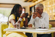 © Jacob Lund - Cheerful senior couple having coffee together in a cafe