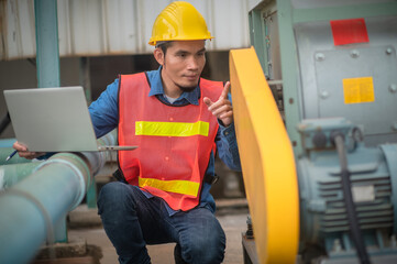 Wall Mural - Asian engineer Indonesian employee worker working metal heavy factory plant, Technician Workman Philippines in Asia checking maintenance machine in manufacturing industrial