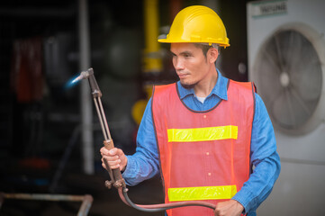 Wall Mural - Technician Workman Philippines in Asia checking maintenance machine in manufacturing industrial, Asian engineer Indonesian employee worker working metal heavy factory plant