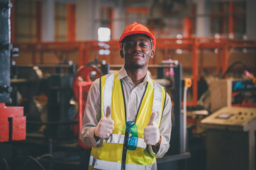 Portrait African American Black afro worker in factory, Cameroon Black man employee work in  production plant manufacture factory industry and operator line machine steel metal using helmet for safety