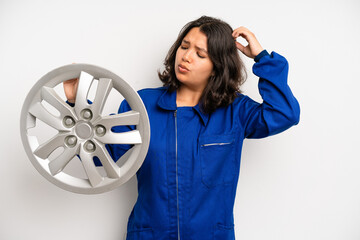 Wall Mural - hispanic pretty girl laughing out loud at some hilarious joke. car mechanic employee