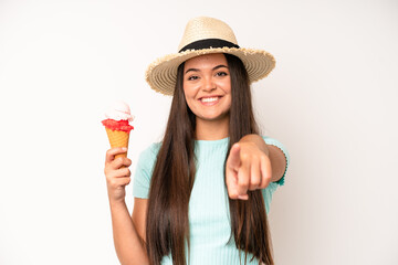 hispanic pretty woma smiling cheerfully, feeling happy and showing a concept. ice cream and summer c