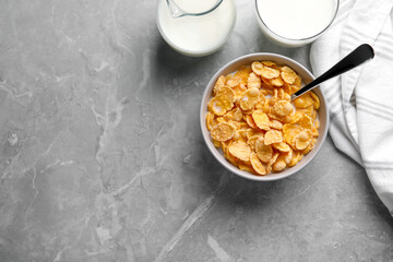 Wall Mural - Tasty cornflakes with milk served on grey marble table, flat lay. Space for text
