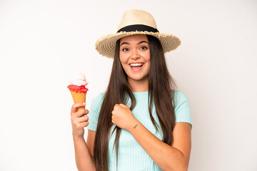 hispanic pretty woma feeling happy and astonished at something unbelievable. ice cream and summer co