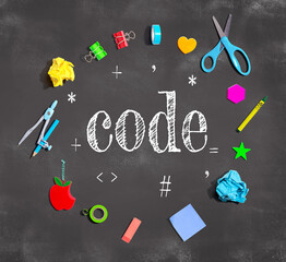 learn to code theme with school supplies on a chalkboard - flat lay