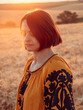 © romanets_v - portrait of young woman in Ukrainian traditional clothes at golden field by sunset light