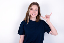 Young Caucasian Woman Wearing Black T-shirt Over White Background Showing Up Number Six Liu With Fingers Gesture In Sign Chinese Language