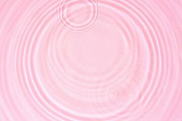 Wall Mural - Cosmetic pink water texture, pink water surface with rings and ripples. Spa concept background