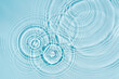 Blue water texture, blue mint water surface with rings and ripples. Spa concept background. Flat lay, copy space.