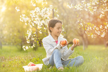 Wall Mural - Beautiful preteen girl enjoy spring apple blooming. Little preschool girl in garden tree flowers. Springtime.