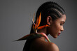 © face_reader_img - African American young woman with paradise flower posing indoor. Mock-up.