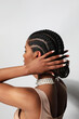 © face_reader_img - Woman's face in profile, hair braided. Isolated against light grey background.