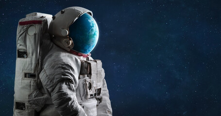 Wall Mural - spaceman with planet earth globe in helmet. astronaut in space. surreal space art. elements of this 