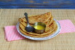indian gujarati traditional sweet stuffed flatbread or sweet roti vedmi also known in india as holige,puran poli served with pure cows ghee clarified butter and papad