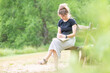 © Lydia - Young woman sitting on a bench reading the Bible