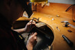 © Cavan Images - jeweler making a silver jewelry