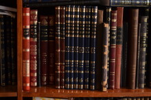 Closeup Of Old Hebrew Jewish Books Or Seforim On A Wooden Bookshelf, Bookcase In Jewish Library Study