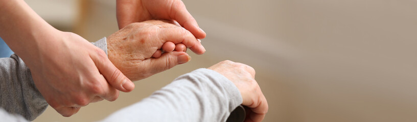 Hands of daughter and her grandmother at home