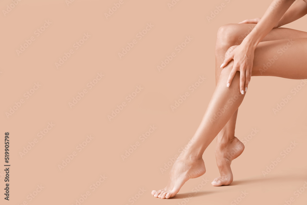 Young tanned woman on beige background