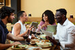 © chika_milan - The coworkers sit together at the business meeting in a restaurant and talk about the project.