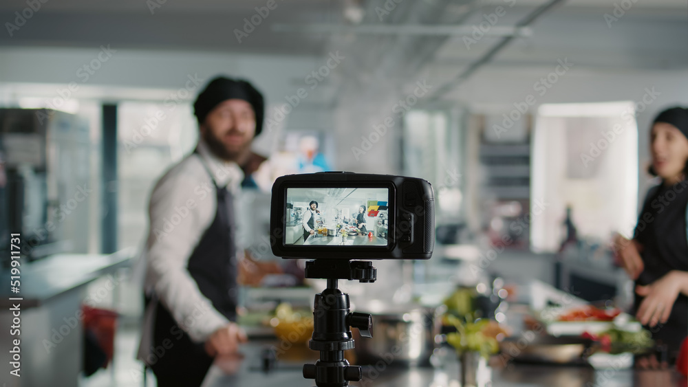 Camera filming people cooking professional menu dish in kitchen ...