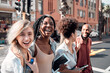 © C Haas/peopleimages.com - A Group of diverse students having fun outdoors in the city on a sunny summer day. Portrait of young people or friends laughing and smiling together in an urban town while walking to campus