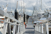 Stainless Steel Rails Of Ramp Leading Down To Marina Piers And Boats