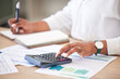 © Malik E/peopleimages.com - Finance, accounts and data analyst planning for tax return and calculating new financial strategy. Professional accountant working with bank reports and invoice charts to calculate income money