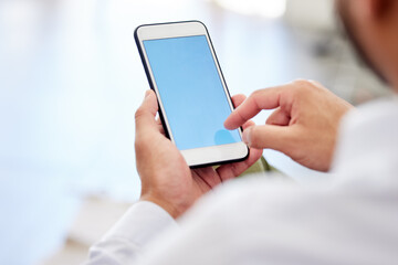 Blank blue screen of a phone with a businessman typing or scrolling the internet. Closeup of corporate or entrepreneur male texting or browsing the web for social media news and clickbait