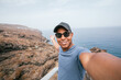 © Cavan - Latin man taking selfie from mountains off coast of island of Tenerife