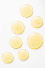 Yellow Drops Of Gel Close Up. Cosmetic Product For Moisturizing The Skin Of The Face Or Body.