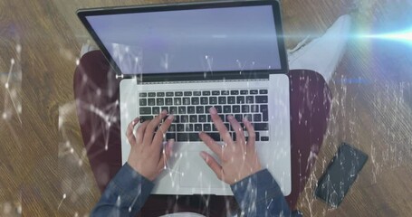 Poster - Animation of network of connections against overhead view of a person using laptop