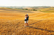 © carlesmiro - Portrait of middle age couple kissing each other at yellow field during summer holidays at Tuscany, Italy. Senior couple wear stylish clothes and hat during sunset.