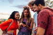 © bernardbodo - Four festival people using phone