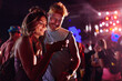 © bernardbodo - Couple using cellphone at music festival